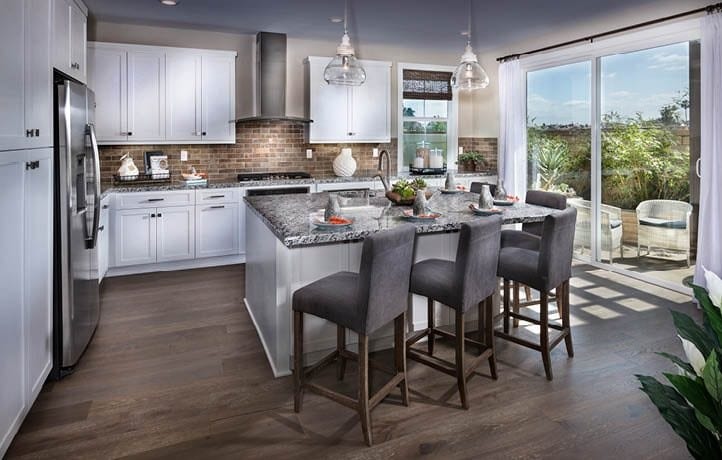 Kitchen rendering featuring island with 3 stools.