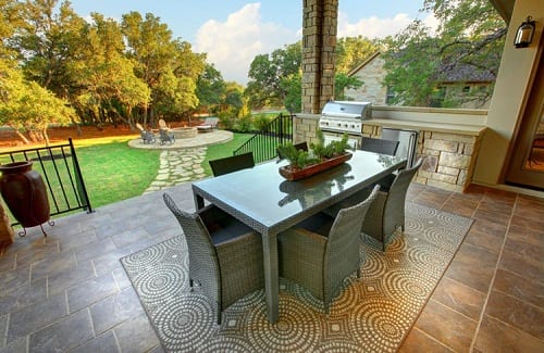 Patio dining area with fire pit in background