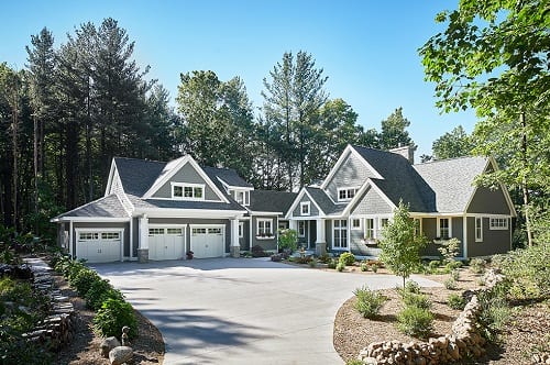 Exterior image of home with 3 car garage layered facade with white trim.