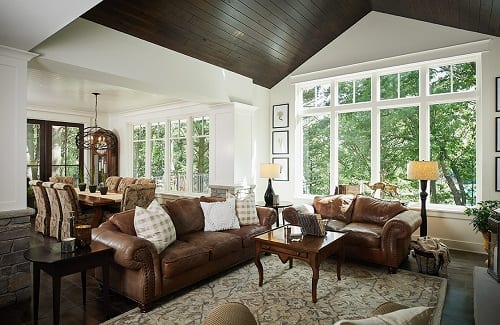 Great room with peaked dark wooded ceiling.