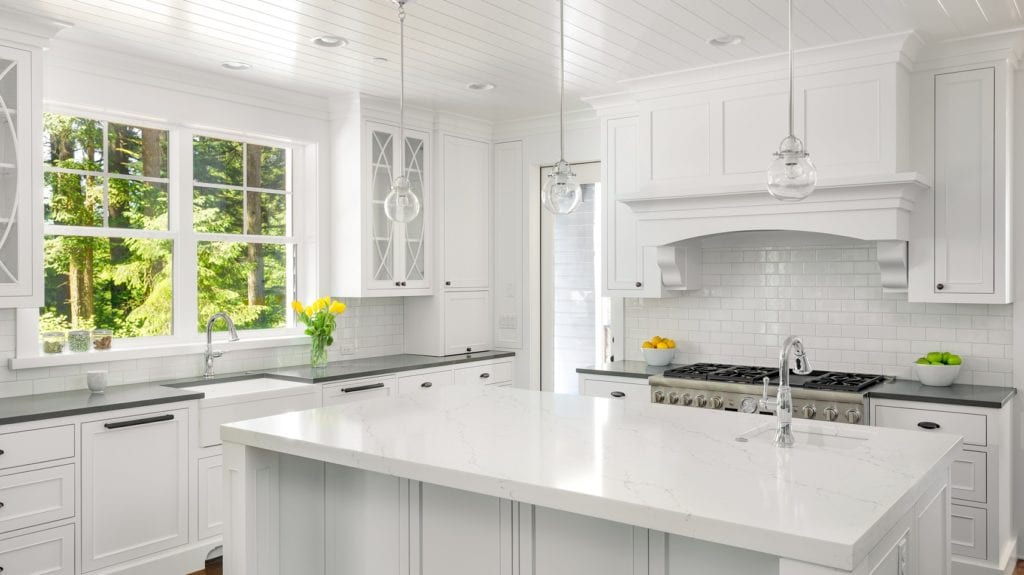 White Kitchen Interior with Island, Sink, Cabinets, and Hardwood