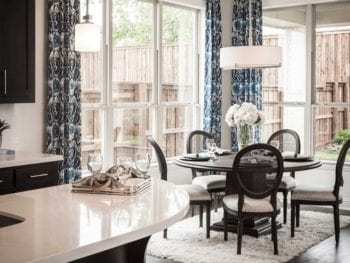 Windows with patterned curtains in breakfast nook.