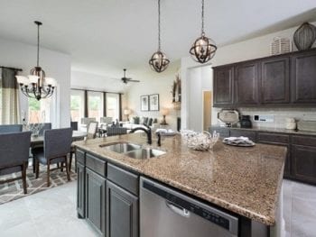 View of kitchen island featuring view of dining area and living area.