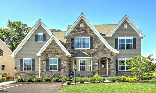 Tudor Revival home with stacked stone on exterior.