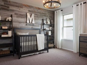 Nursery with wood feature wall.
