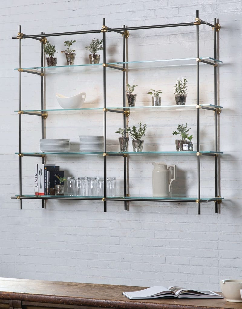 Glass shelving on painted brick wall.
