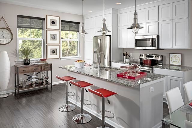 Bright white kitchen with an island large enough for 3.