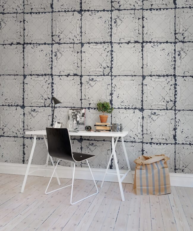 Reclaimed pressed metal tiles on a wall.